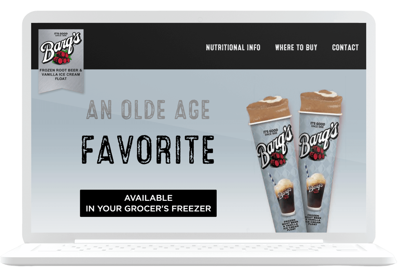A laptop screen displaying a website advertising "Barq’s Frozen Root Beer & Vanilla Ice Cream Float." The text says, "An Olde Age Favorite" and "Available in your grocer’s freezer." There are images of two frozen root beer float packages on the right side.