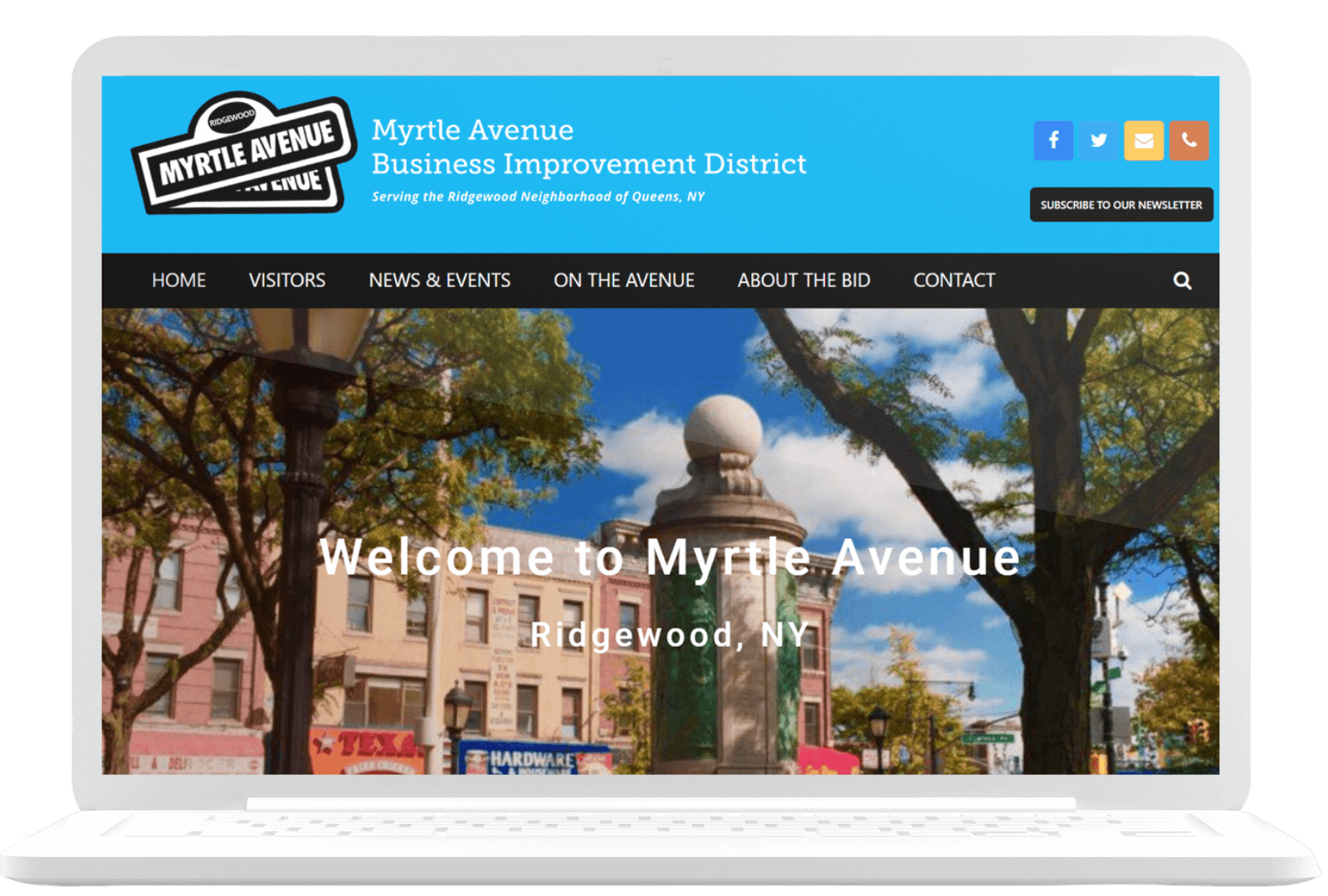 A laptop screen displays the Myrtle Avenue Business Improvement District website. The header includes navigation links and social media icons. The main section has a welcome message against a backdrop of a street with trees and buildings in Ridgewood, NY.